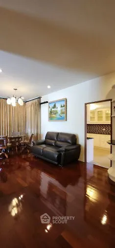 Spacious living room with polished wooden floors and elegant decor
