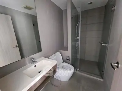 Modern bathroom with sleek fixtures and glass shower enclosure