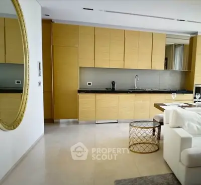Modern kitchen with sleek wooden cabinets and open layout in luxury apartment.
