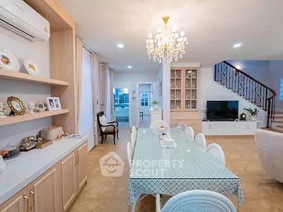 Elegant dining room with chandelier, spacious table, and stylish decor in a modern home interior.