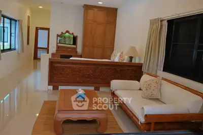 Spacious living room with elegant wooden furniture and natural light