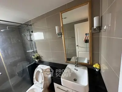 Modern bathroom with sleek fixtures and elegant mirror design