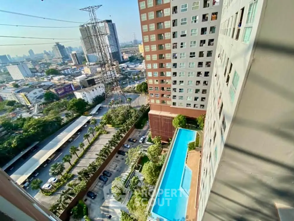 Stunning high-rise apartment view with pool and cityscape, perfect for urban living.
