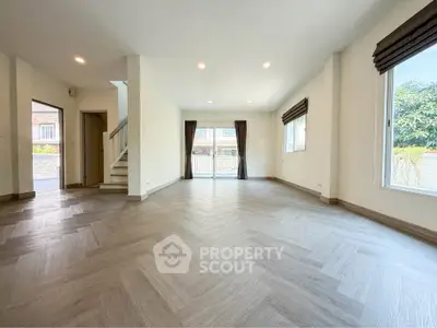 Spacious empty living room with large windows and modern flooring