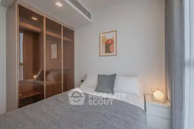 Cozy modern bedroom with stylish decor and ample natural light