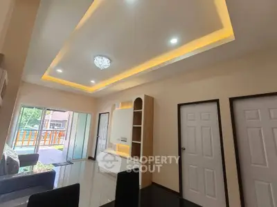 Spacious living room with modern ceiling design and natural light
