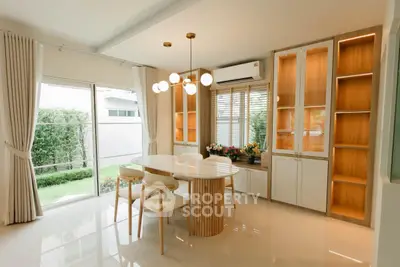 Elegant dining area with modern lighting and garden view