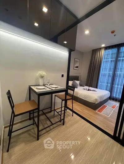 Modern studio apartment with cozy dining area and stylish bedroom