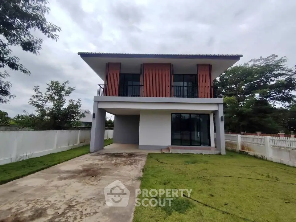 Modern two-story house with large windows and spacious driveway in a serene neighborhood.