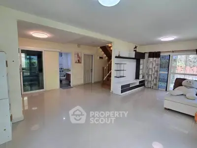 Spacious modern living room with open layout and elegant staircase