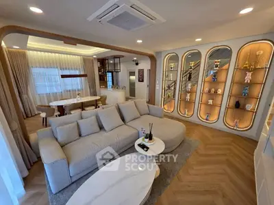 Luxurious modern living room with elegant decor and open layout, featuring a cozy sofa and stylish display shelves.