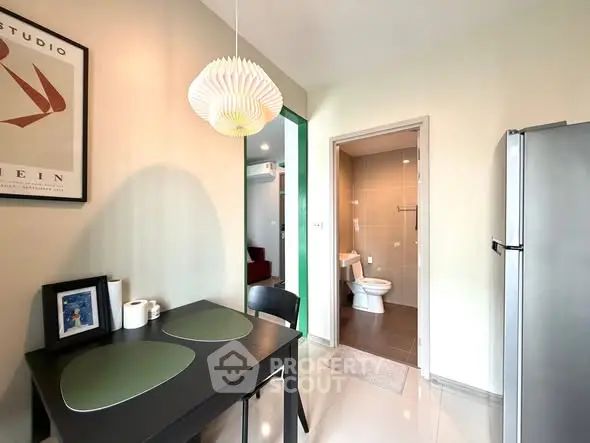Modern kitchen with dining area and view into a sleek bathroom