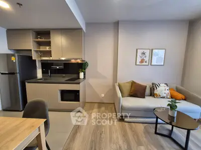 Modern open-layout kitchen and living room with stylish decor and cozy seating area.