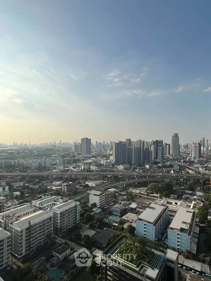 Stunning cityscape view from high-rise building showcasing urban skyline and clear blue sky.