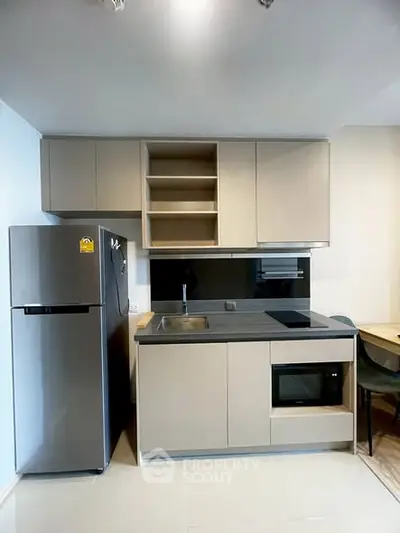 Modern kitchen with sleek cabinetry and built-in appliances in a stylish apartment.