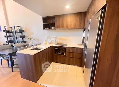 Modern kitchen with wooden cabinets and sleek appliances in open layout design.