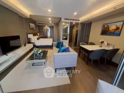 Luxurious open-plan living room with modern decor and elegant dining area in a stylish apartment.