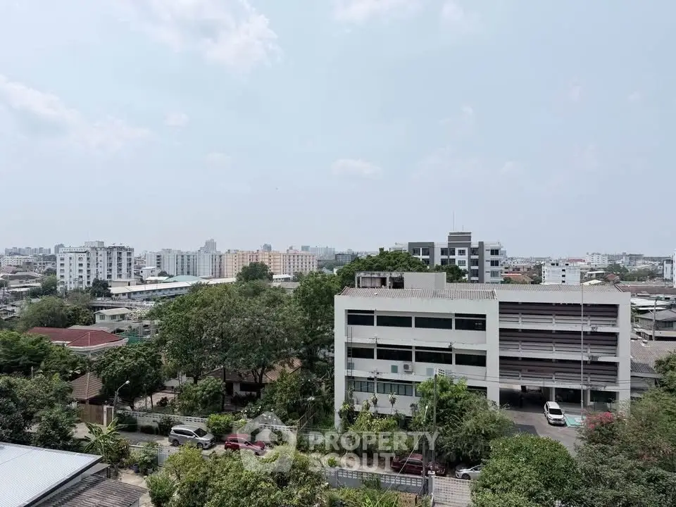 Stunning cityscape view from a high-rise building showcasing urban living and lush greenery.