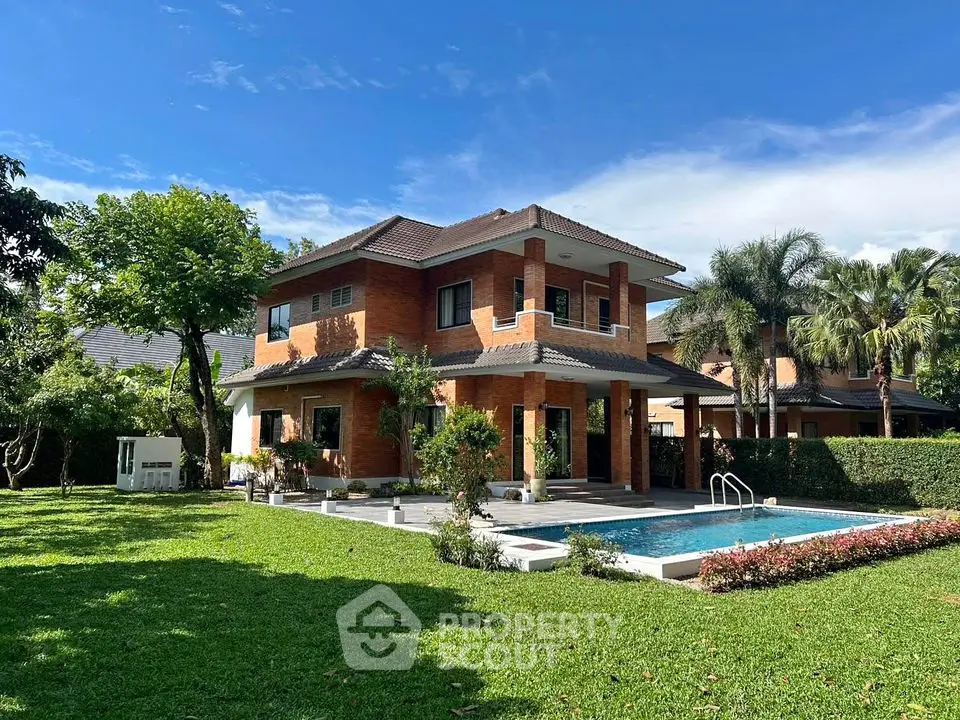 Luxurious two-story brick house with private pool and lush garden