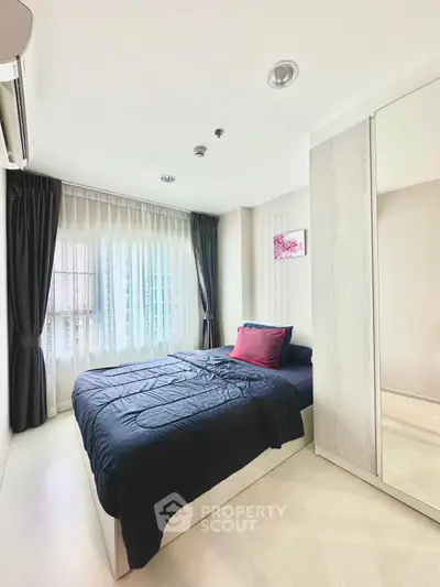 Modern bedroom with large window and stylish decor in a high-rise apartment.