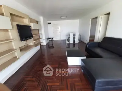 Spacious living room with modern furniture and wooden flooring
