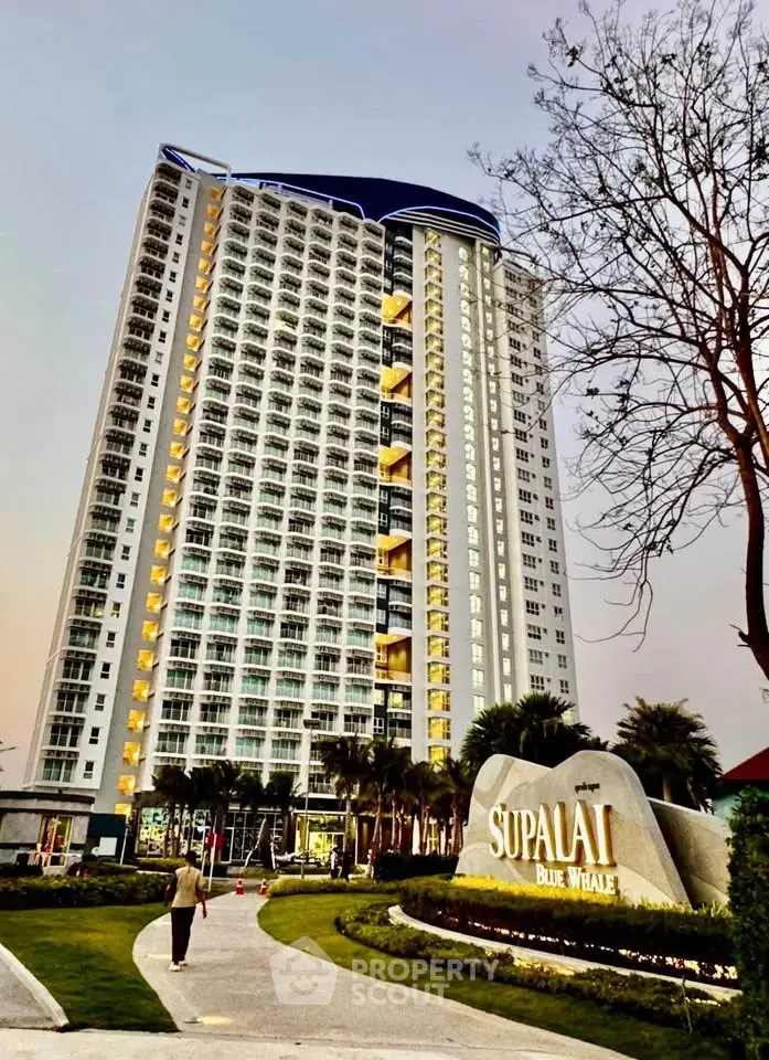 Stunning high-rise building with modern architecture and lush landscaping at Supalai Blue Whale.