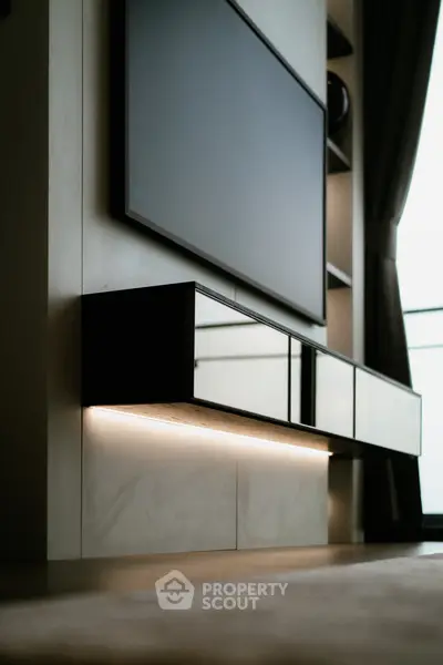 Modern living room with sleek TV unit and ambient lighting