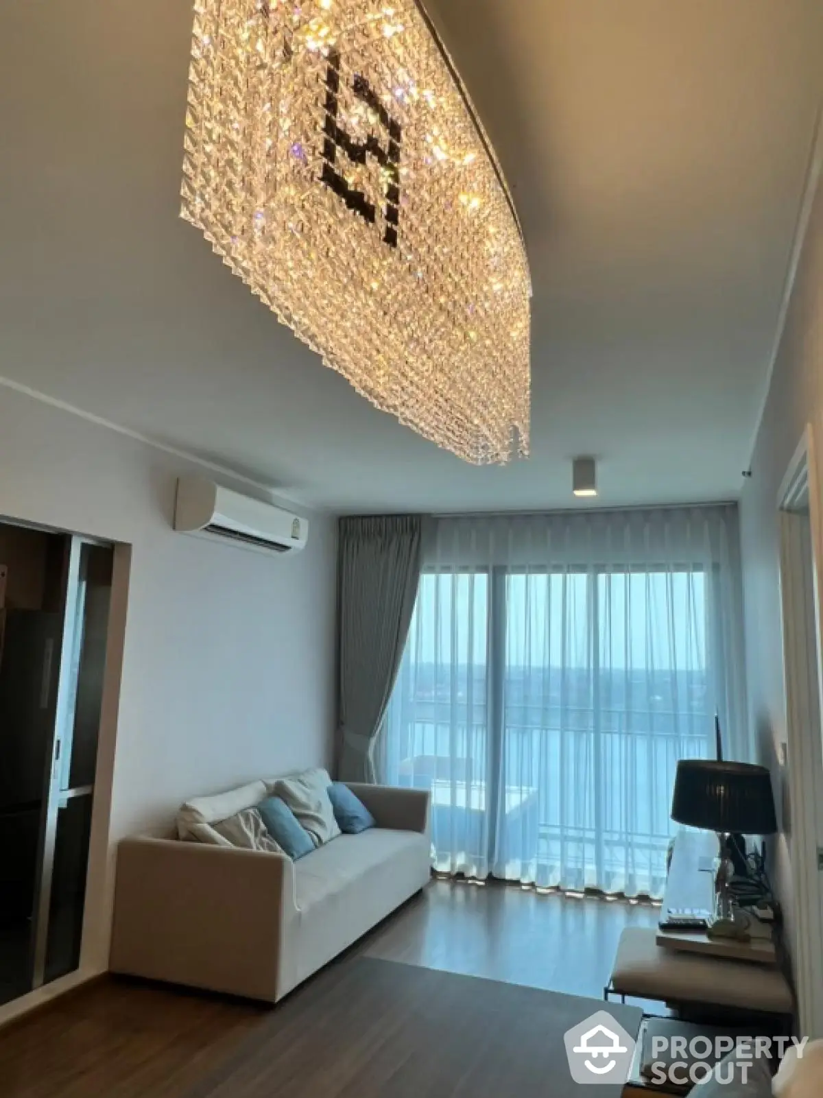 Elegant living room with stunning chandelier and panoramic window view