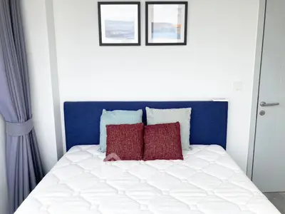 Modern bedroom with stylish decor and cozy bedding in a bright apartment.