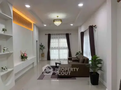 Spacious modern living room with elegant chandelier and cozy seating area.