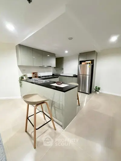 Modern kitchen with sleek design, featuring stainless steel appliances and open layout.