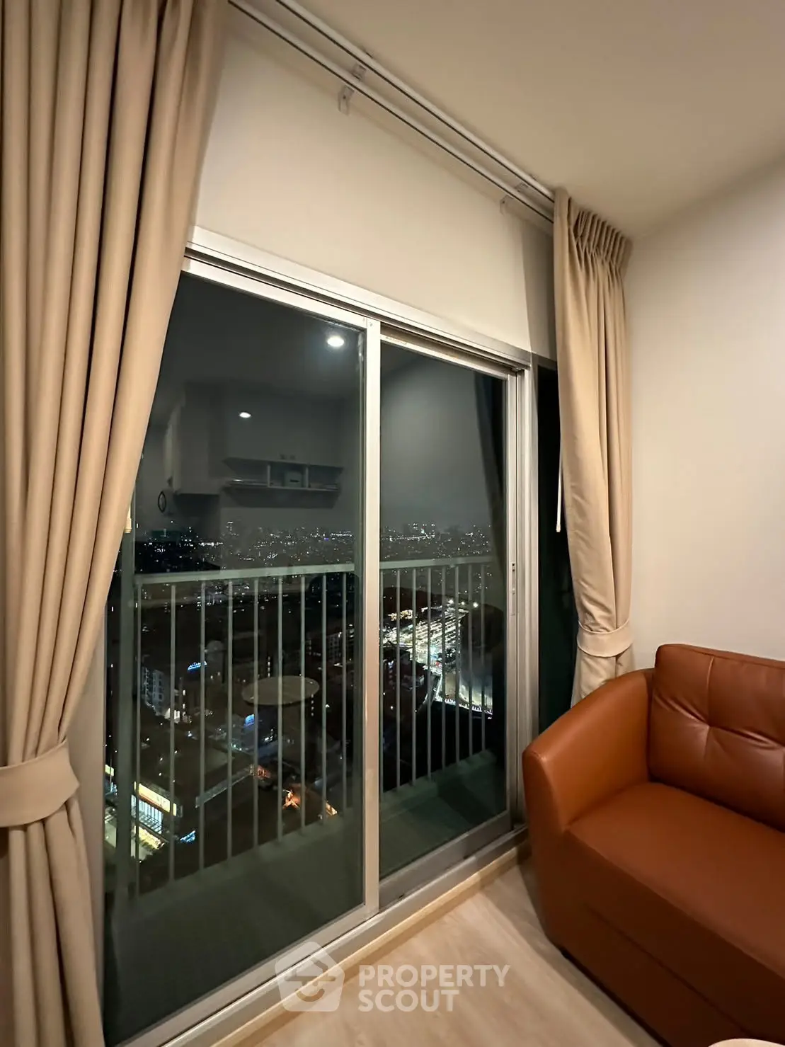 Stunning high-rise apartment with floor-to-ceiling windows offering breathtaking city views.