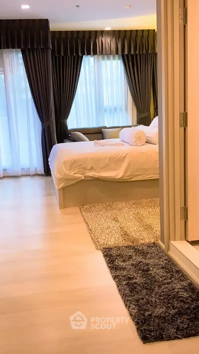 Luxurious bedroom with elegant curtains and cozy lighting in modern apartment