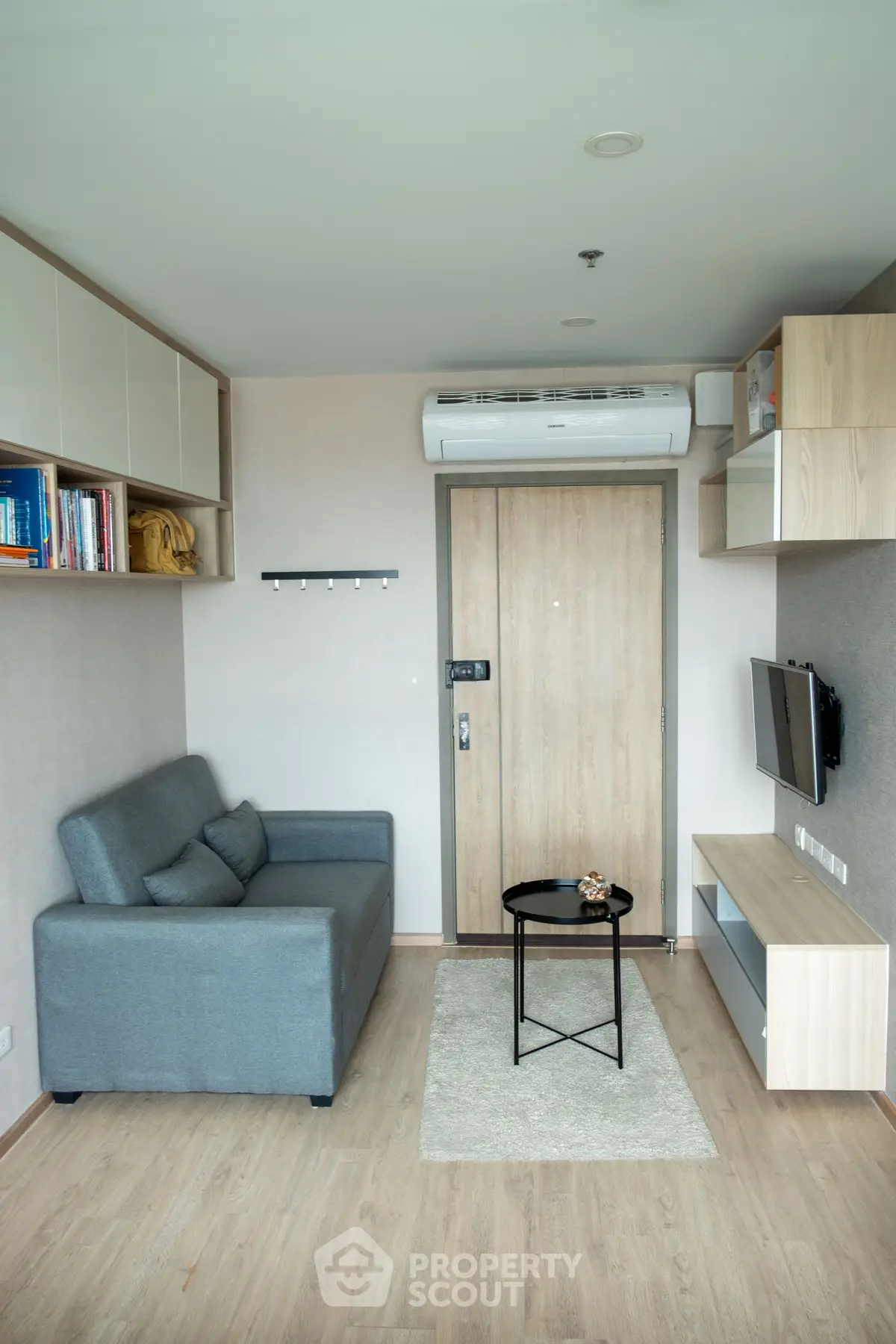 Modern living room with sleek furniture and air conditioning in a cozy apartment.