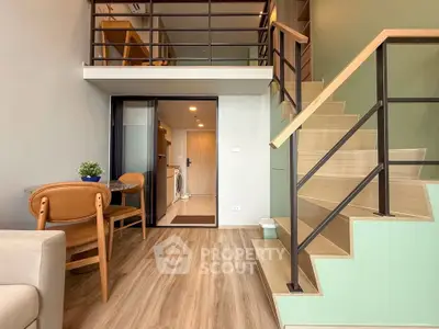 Modern duplex apartment with stylish staircase and cozy dining area