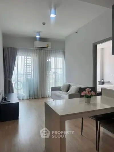 Modern living room with natural light and stylish decor in a contemporary apartment.