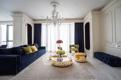 Luxurious living room with elegant chandelier and plush velvet seating