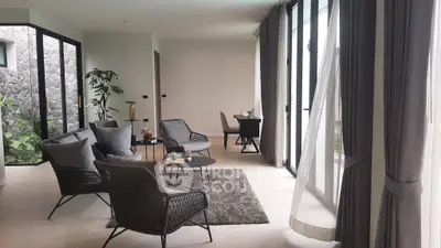 Modern living room with stylish furniture and large windows for natural light