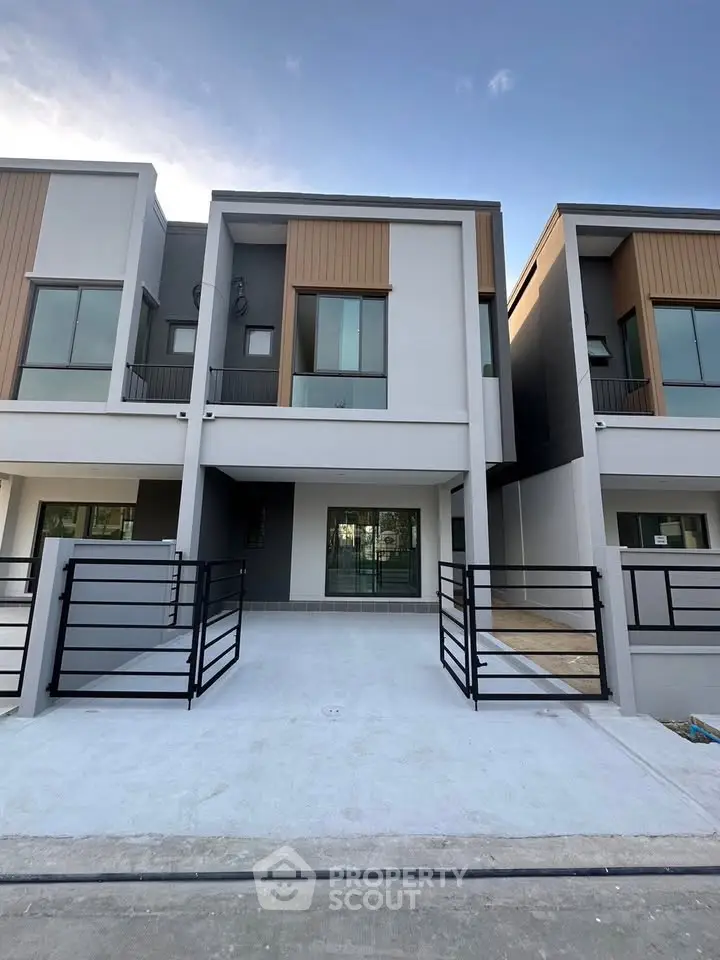 Modern townhouse exterior with sleek design and spacious driveway