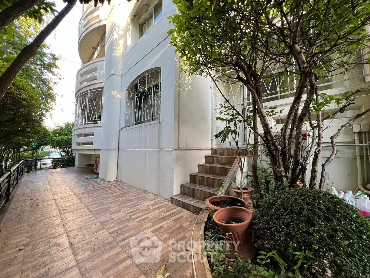 Charming building exterior with lush greenery and inviting entrance