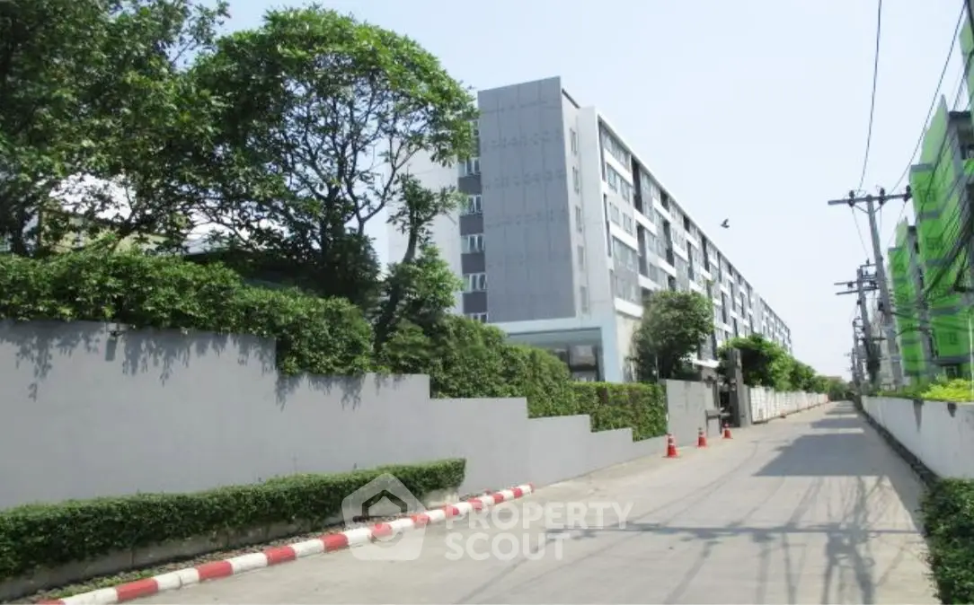 Modern residential building with lush greenery and spacious driveway
