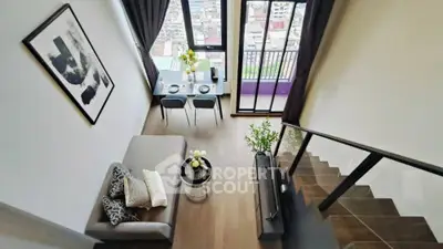 Modern loft apartment with stylish decor and stunning city view from balcony.