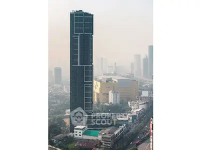 Stunning skyscraper with modern architecture in bustling cityscape, ideal for urban living or investment.