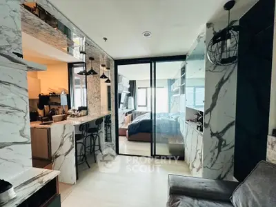 Luxurious modern apartment with marble accents and open layout, featuring a stylish kitchen and cozy living area.