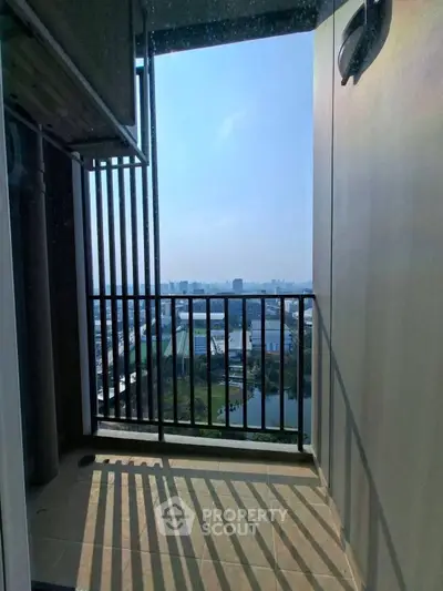 Stunning high-rise balcony with panoramic city view, perfect for relaxation and enjoying the skyline.