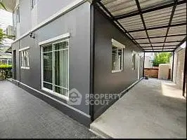 Modern exterior view of a sleek corner unit with covered parking area.