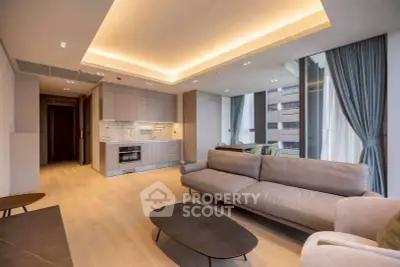Luxurious modern living room with open kitchen and elegant lighting in a high-rise apartment.