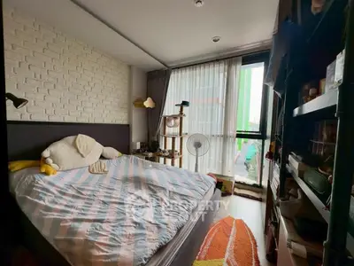 Cozy bedroom with large window and modern decor in urban apartment