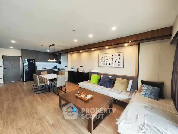 Spacious modern living room with open kitchen and stylish decor.