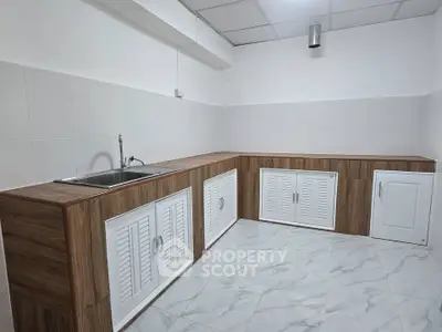 Modern kitchen with sleek wooden cabinetry and tiled flooring